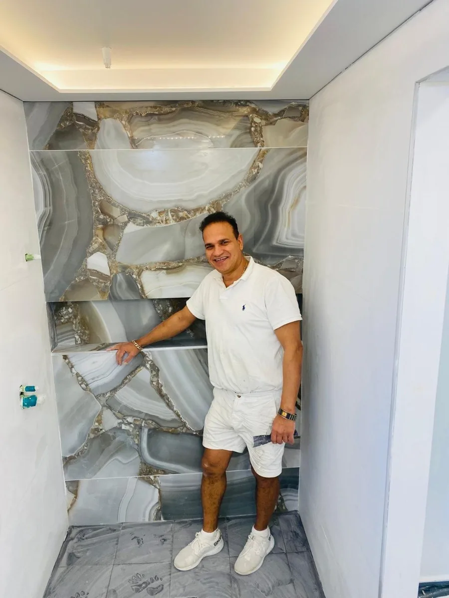 Luxury bathroom with book-matched agate feature wall and polished plaster ceiling, Northern Beaches — Jack's Plastering finish backed by 2-year guarantee